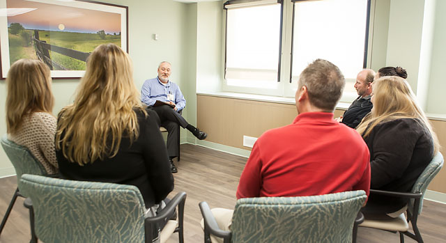 Counselor meeting with a group of patients