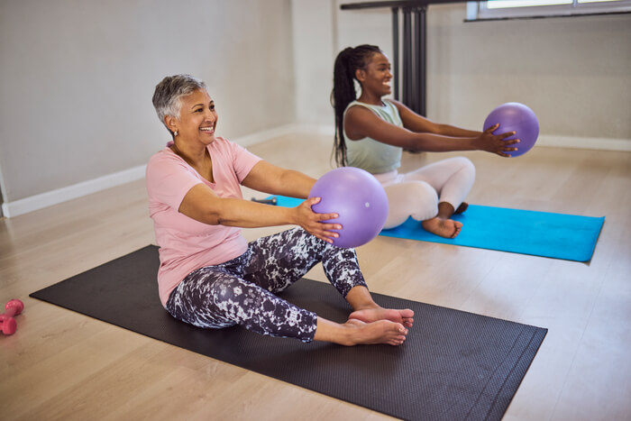 Smiling women in low-impact exercise class.