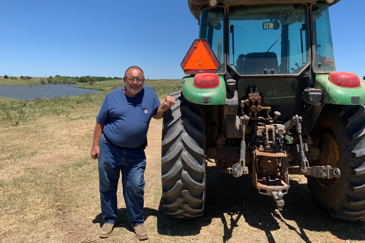 Larry LeCrone with farm equipment