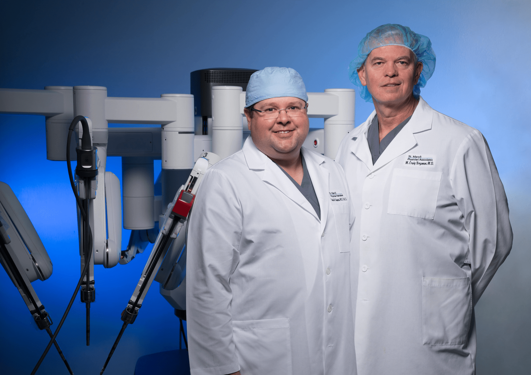 Dr. Bozeman and Dr. Shepard standing in front of robotic-assisted surgery tools