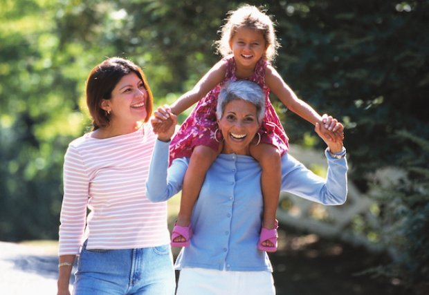 Active senior carrying child on shoulders