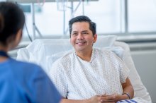 A male patient talking to a female nurse