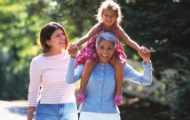 Active senior carrying child on shoulders